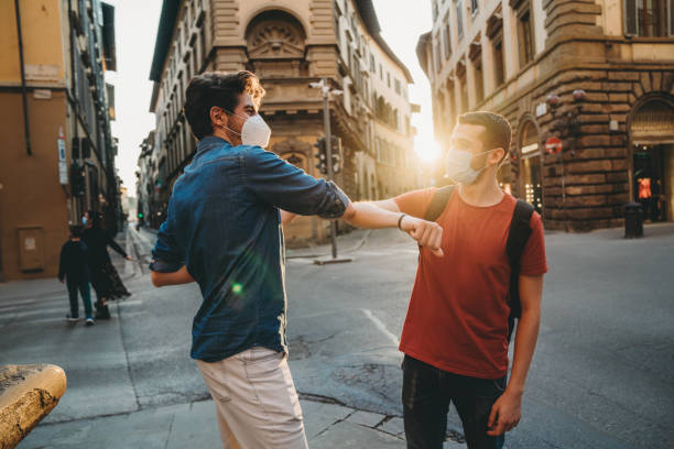 Two friends greeting each other with the elbow