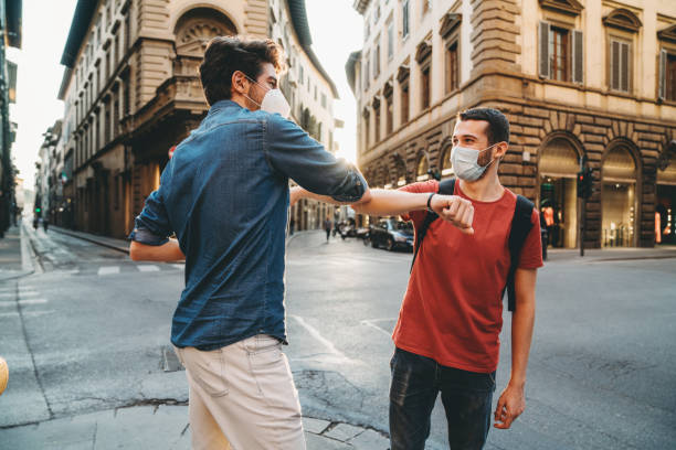 istock Two friends greeting each other with the elbow 1244402495