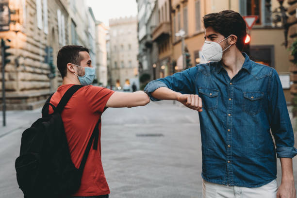 istock Two friends greeting each other with the elbow 1244402501