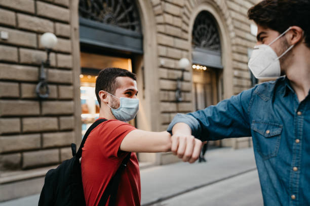 istock Two friends greeting each other with the elbow 1244402502