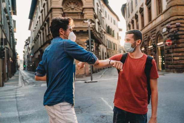 istock Two friends greeting each other with the elbow 1244402508