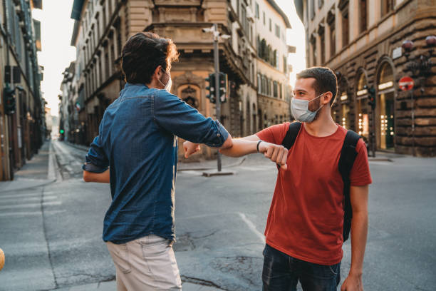 istock Two friends greeting each other with the elbow 1244402526