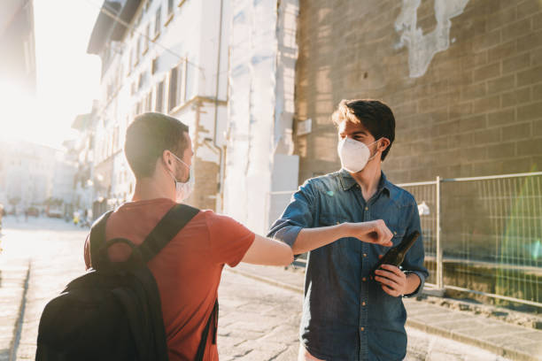 istock Two friends greeting each other with the elbow 1244402540