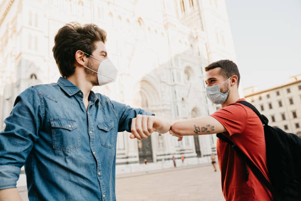 istock Two friends greeting each other with the elbow 1244402543