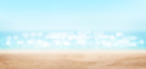 Summer tropical sea with sparkling waves, sand and blue sunny sky