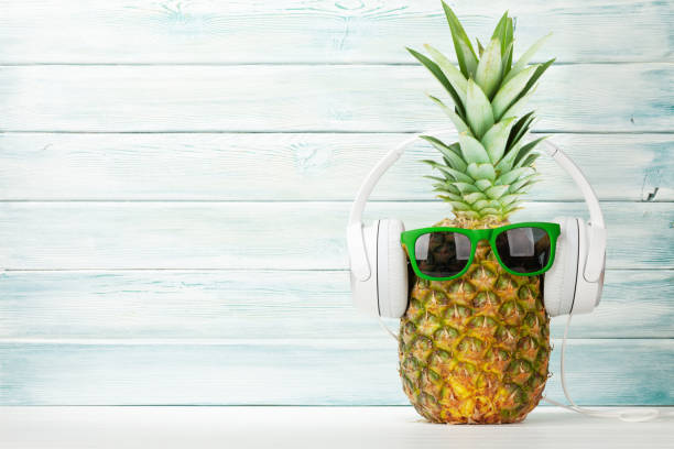 istock Ripe pineapple with sunglasses and headphones 1244413079