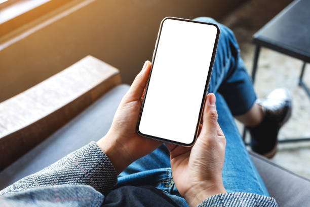 istock a woman holding mobile phone with blank white desktop screen 1244416890