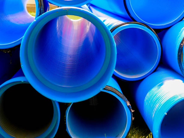 Double-layer blue PVC water pipes Blue corrugated polypropylene pipes used on the construction site. Double-layer blue PVC water pipes unpacked for installation. Close up pipe tube photos stock pictures, royalty-free photos & images