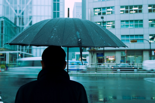 Tokyo rainy background, focus on man and umbrella