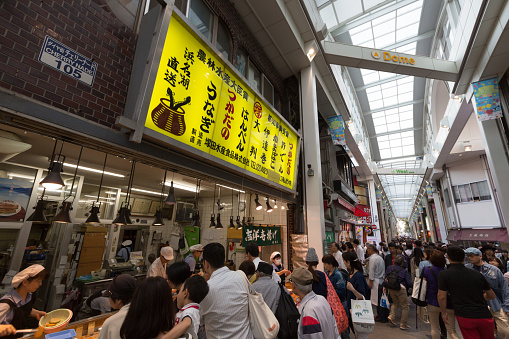 Tokyo, Japan - May 11, 2015: Famous Tsukiji fish market shops. Tsukiji is the biggest fish market in the world, with a vast varaiety of Fish and sea food. with people.