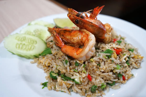 istock Close up Shrimp fried rice decorated with sliced cucumber 1244439155