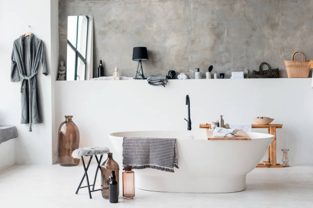 istock Modern bathroom interior with minimalistic shower and lighting, white sink and bathtub 1244442413
