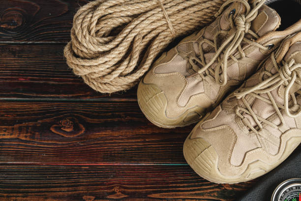 istock Hiking boots and rope hank on wooden board 1244449254