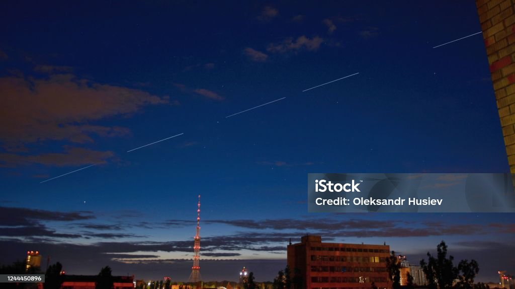StarLink satellites Ilona Musk fly in the sky KYIV, UKRAINE - JUNE 04, 2020: StarLink satellites Ilona Musk fly in the sky over Kiev Elon Musk Stock Photo