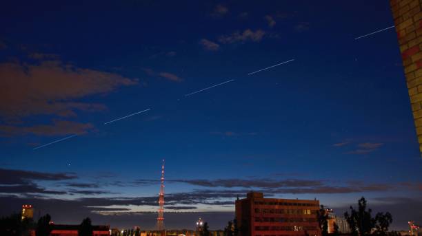 StarLink satellites Ilona Musk fly in the sky KYIV, UKRAINE - JUNE 04, 2020: StarLink satellites Ilona Musk fly in the sky over Kiev elon musk stock pictures, royalty-free photos & images