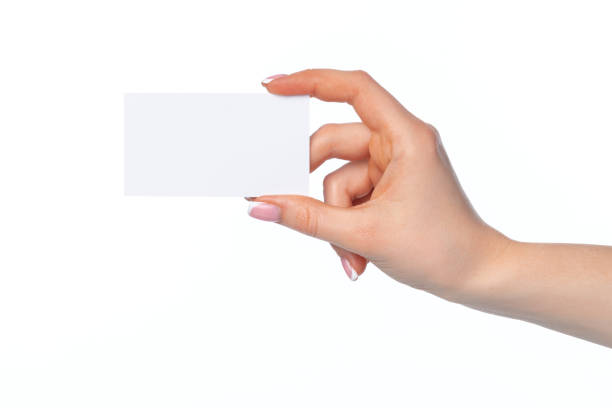 istock Female hand with blank white business card isolated on white 1244455728