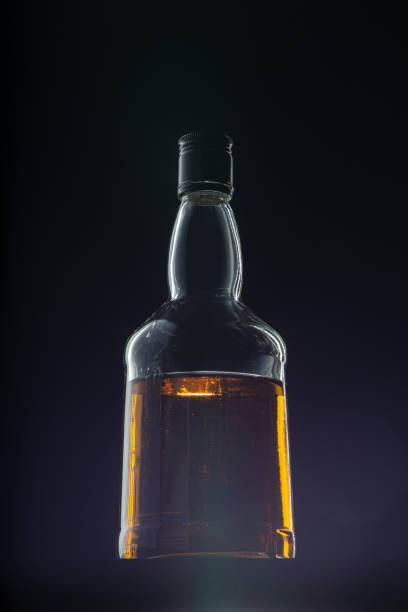 istock Bottle of whisky on black background, copy space 1244461551