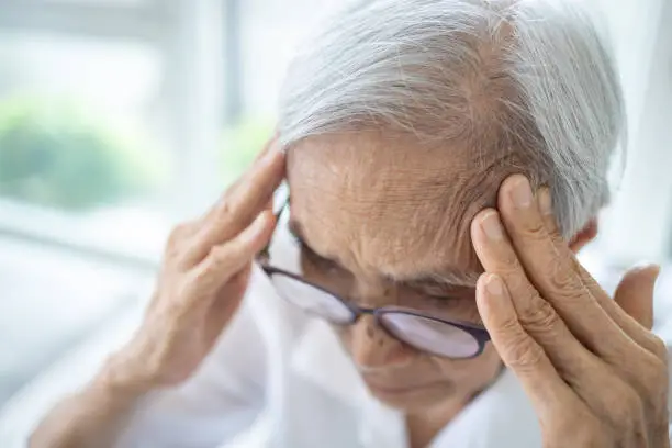 Photo of Sick senior woman with headache,pain in the head,brain system problems,chronic illness,elderly has dizziness,symptoms of benign paroxysmal positional vertigo,meniere's disease or fatigue,lack of sleep