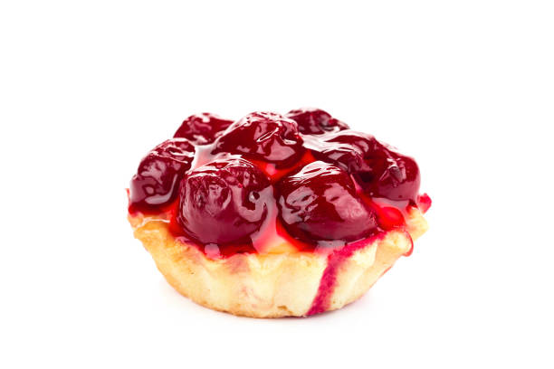 Fresh fruit pie tart with with cherry on a plate. Isolated in a white background. Close-up.