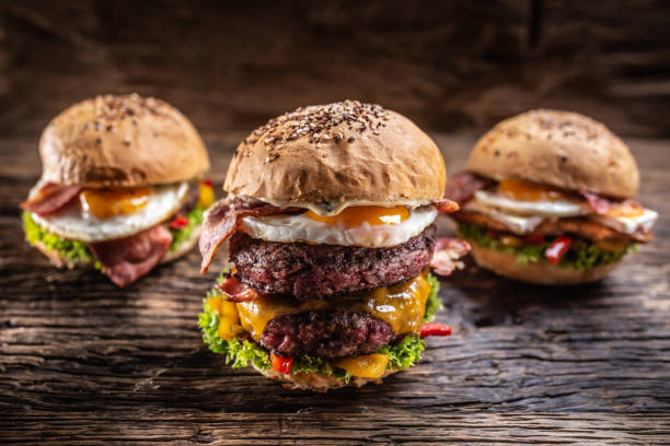 istock Menu selection of various fresh burgers on a wooden surface. 1244493952
