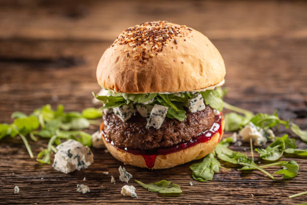 istock Beef burger with arugula, blue cheese and cranberry sauce in a sesame bun. 1244495692