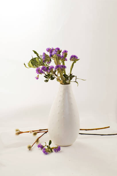 istock Spring lilac flowers with willow branches in a vase. 1244496146