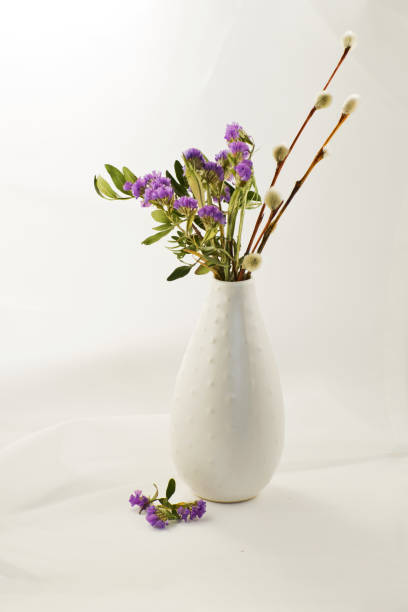 istock Spring lilac flowers with willow branches in a vase. 1244496150