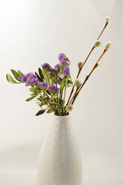 istock Spring lilac flowers with willow branches in a vase. 1244496152