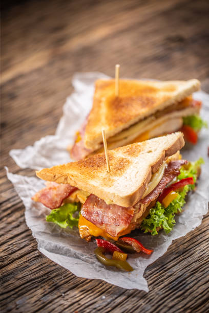 club sandwich on a rustic table witch chicken, bacon and veg. - sandwich club sandwich ham turkey imagens e fotografias de stock