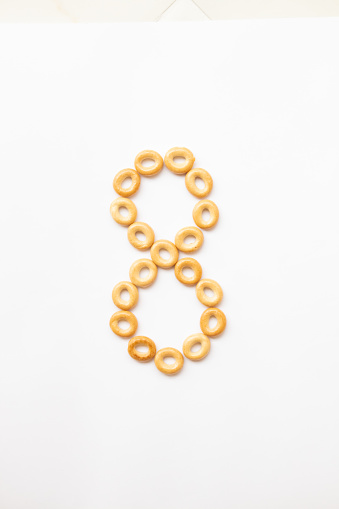 number 8 made from cookies on a white background with space for text. layout for school or diet.