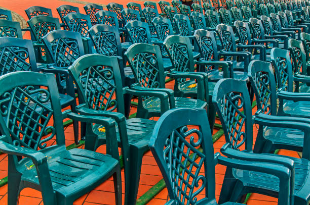 istock Stack of green plastic chair in the city square 1244519922