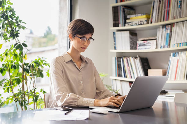 istock Young woman working on laptop 1244519936