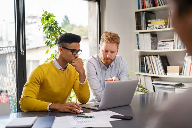 Photo of Creative business people working on laptop