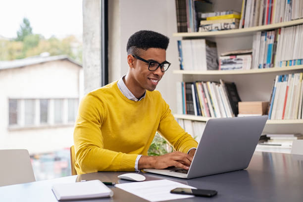 istock Happy young businessman working on laptop 1244523282
