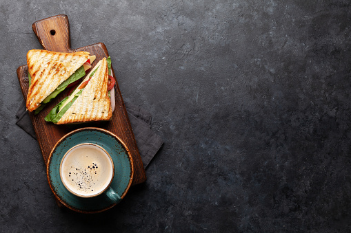 Club sandwich and coffee cup. Breakfast meal. Top view with copy space