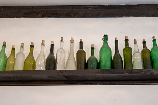 Various types of wine bottles,  filled with different types of old wine