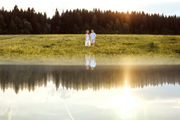 istock Loving couple in the river. Sunset. 1244555166