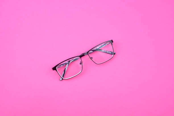 istock Black-white sight glasses with clear lenses on pink surface. 1244557434