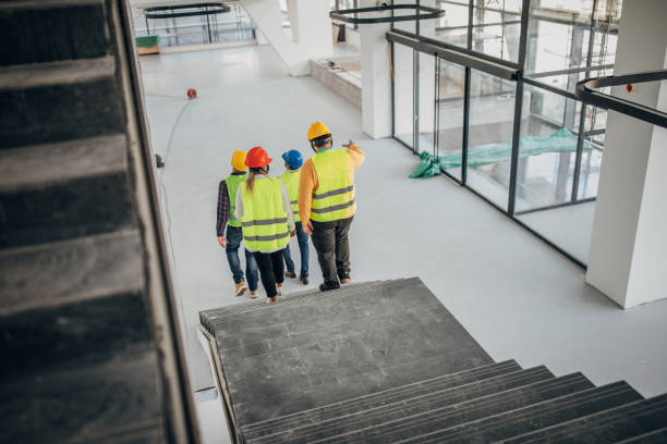 istock Group of architects walking together at construction site indoors 1244567737