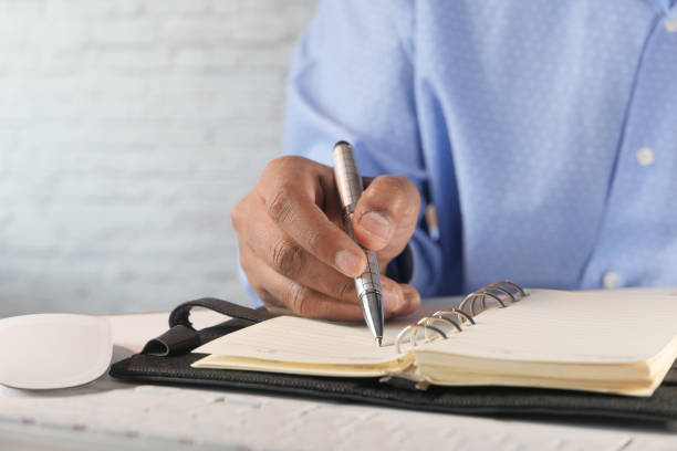 istock businessman hand writing on notepad, close up 1244573463