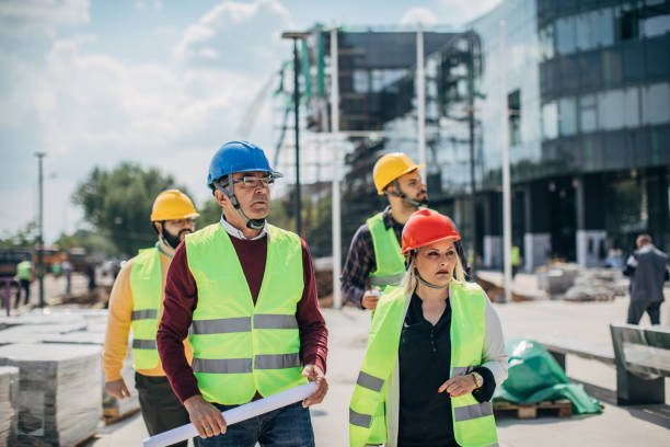 istock Four architects walking at construction site outdoors 1244574037