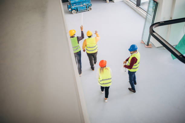 istock Four architects coworkes walking at construction site indoors 1244574656