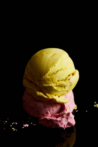 istock delicious lemon, strawberry ice cream balls on black 1244581096