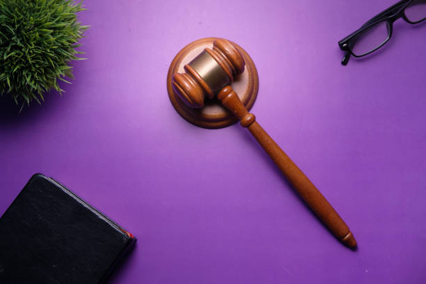 istock high angle view of gavel and book on purple background 1244617231