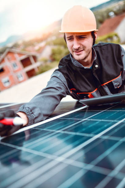 istock Male Worker Taking Notes About Parts Of Solar Panel For Repairing 1244633319