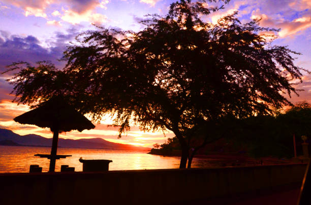 Silhouette picture of childrens playing alongside in Kelapa Beach, Dili, East Timor, Timor Leste