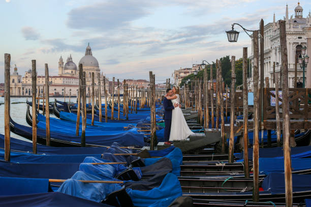 istock beautiful wedding couple posing on dock near blue gondolas 1244650872