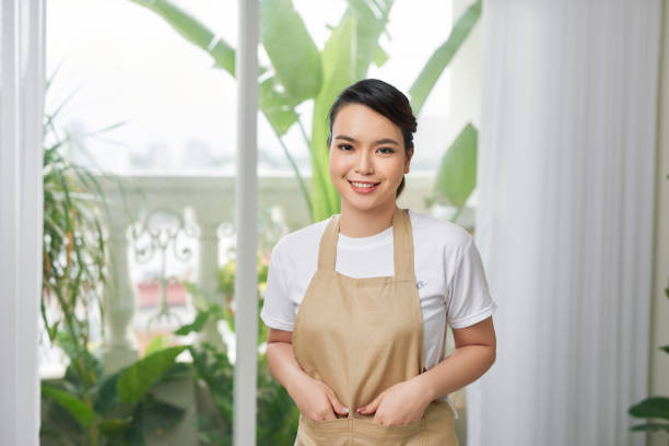 istock Young woman in apron at home 1244651956