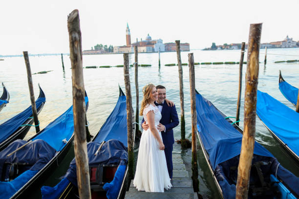 istock beautiful wedding couple posing on dock near blue gondolas 1244651961