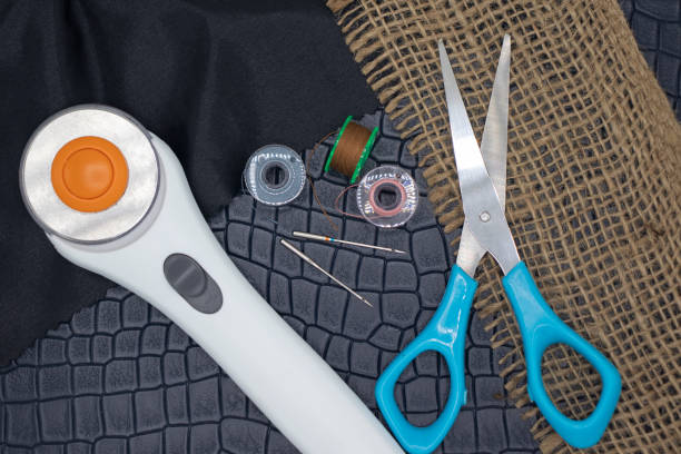 istock Sewing machine essentaisl on a faux leather background 1244652505